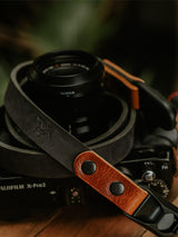 Lavietnamita leather camera strap handmade in Belgium with full grain leather wrap around camera in two colours black and whiskey